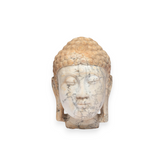 A carved Buddha head sculpture made of marbled stone with beige, gray, and white veining, set against a solid white background.