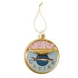 A round gold-framed Christmas ornament featuring a salmon caviar design with a pink textured top half, a light blue lower half, a blue salmon fish logo in the center, and the word 'CAVIER' in gold lettering. It hangs from a gold string on a plain white background.