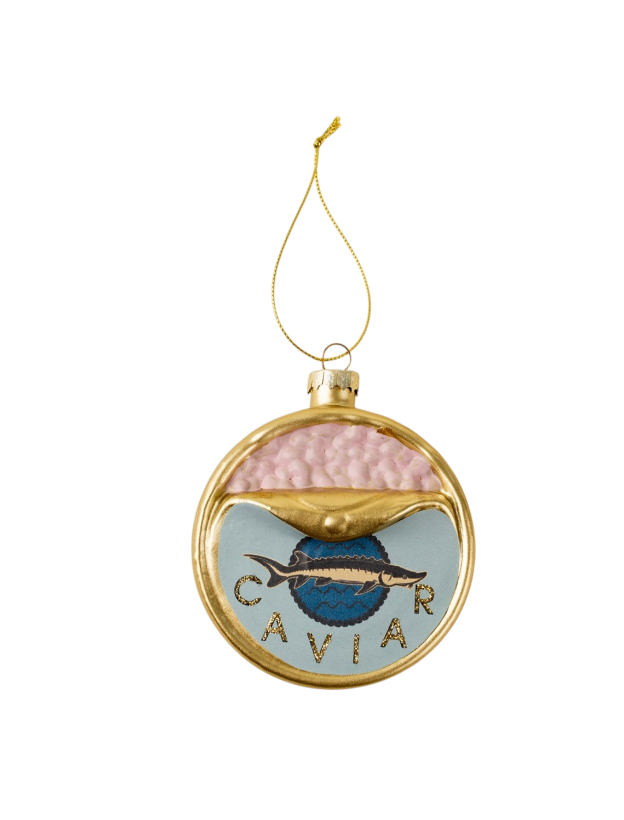 A round gold-framed Christmas ornament featuring a salmon caviar design with a pink textured top half, a light blue lower half, a blue salmon fish logo in the center, and the word 'CAVIER' in gold lettering. It hangs from a gold string on a plain white background.