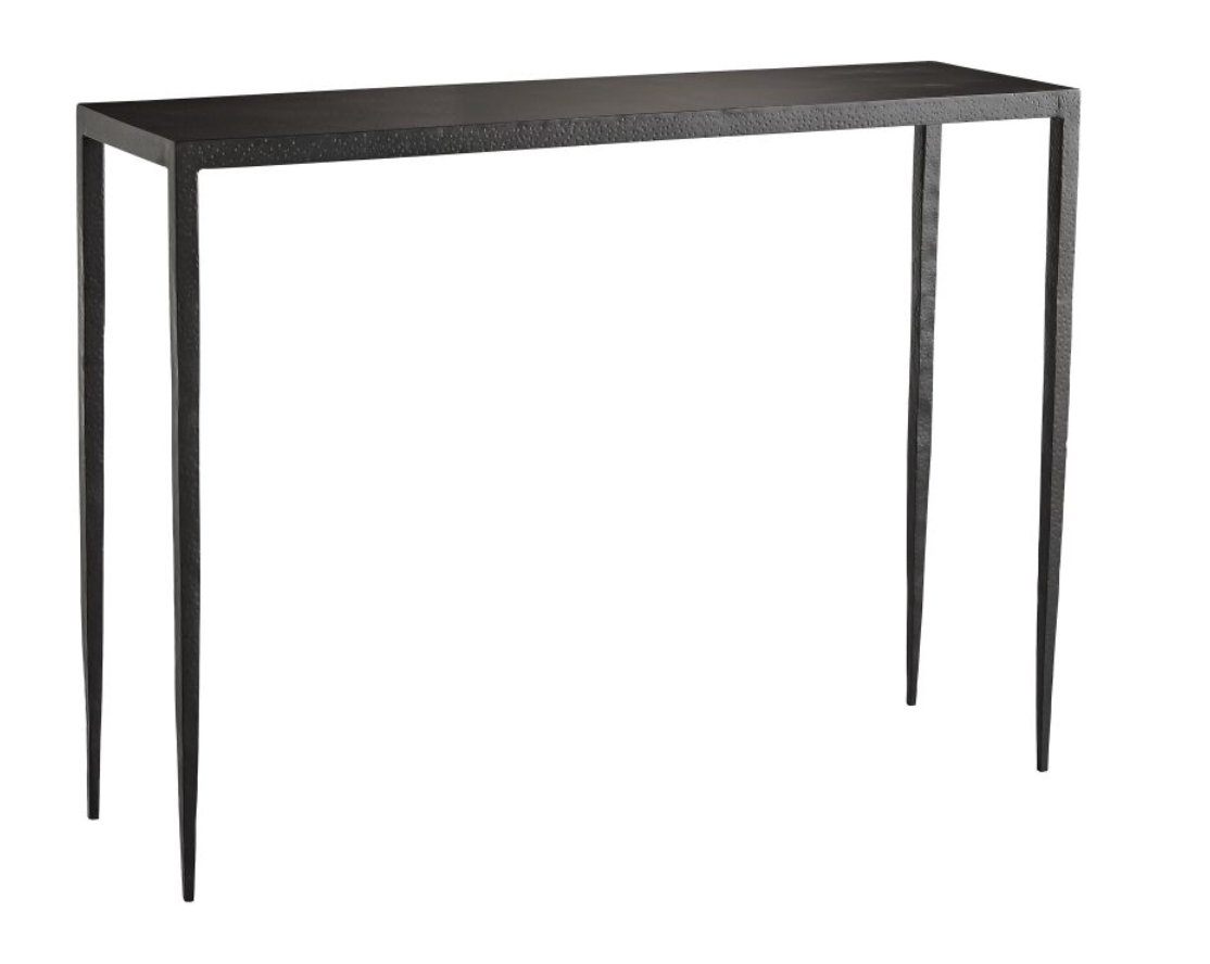 This Hammered Iron Console is Simple and stylish. Crafted from solid iron that has been hammered by hand lending a textured touch to its industrial frame. An ultra-thin top blends into slightly tapered legs that appear delicate but asire extremely steady. Visually lightweight it offers an airy aesthetic