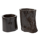 Two rustic dark wood cylindrical planters with natural bark-like textures, shown on a plain white background.