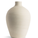 This smooth ceramic vase is combining functionality and sculptural elegance with its hand-formed round silhouette and cream finish