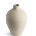 This smooth ceramic vase is combining functionality and sculptural elegance with its hand-formed round silhouette and cream finish