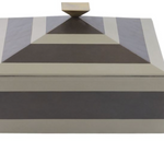 Tonal stripes add a tailored finish to a two-toned dove and graphite leather box. This pyramid-inspired accessory is topped with a bronze-plated handle that reflects its geometric lines. Lined in soft suede. 