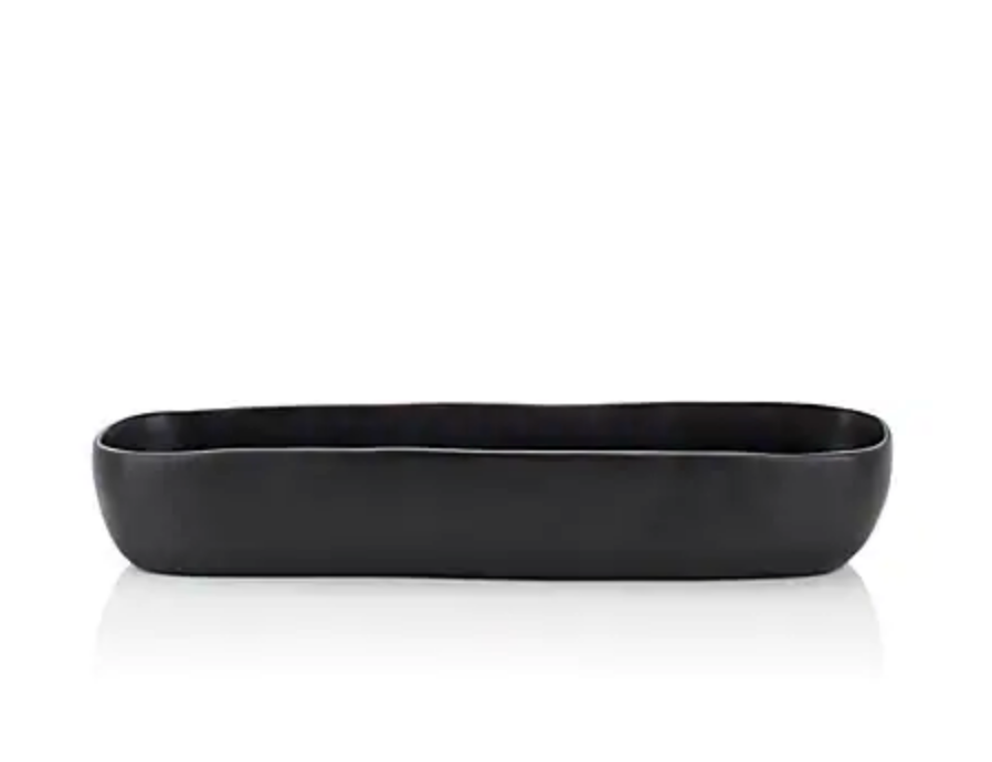 Black Resin troughs by Tina Frey Designs'  is hand-sculpted of black shatter-resistant BPA-free resin and features organic-shaped edges. The food-safe vessel can hold fruit, display decorative objects, or simply serve as a statement piece in the space of your choosing.